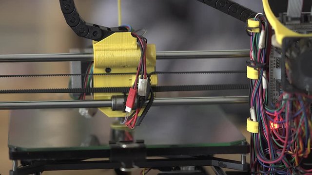 3D printer at work. 3D printing, additive manufacturing (AM), refers to processes used to create a three-dimensional object in which successive layers of material are formed under computer control