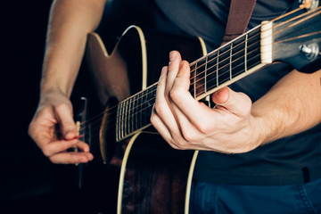 Fototapeta na wymiar Female hand playing on acoustic guitar. Close-up.