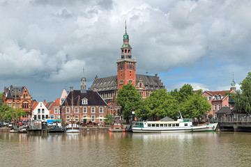 Leer, Germany. View from Leda river on the City Hall in Dutch Renaissance style, the Old Weigh...