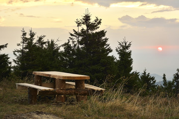 Sunrise in the mountains and wooden table