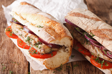 Sandwiches with fried mackerel and vegetables close-up. Horizontal