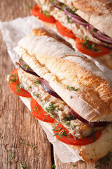 Turkish sandwich balik ekmek with fried mackerel close-up. vertical