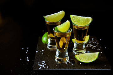Strong alcohol drinks. Tequila shots with salt and lime slices.