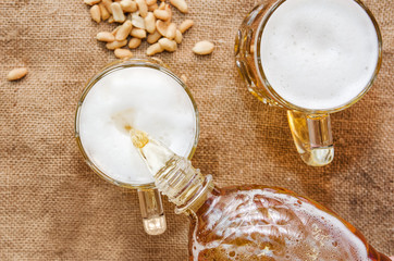 pour beer into a glass from a bottle