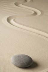 Fototapeta na wymiar zen meditation stone and sand, sheng fui Buddhism in a spiritual japanese rock garden. Abstract harmony and balance concept for purity concentration spa relaxation..