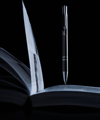 Pen on a opened book. Macro image. library, education,