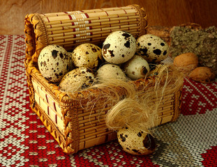 quail eggs, in a decorative basket and fiber
