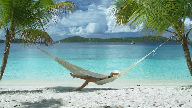 video of a woman relaxing in hammock on perfect tropical beach