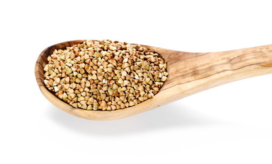 Buckwheat in wooden spoon, isolated on white background