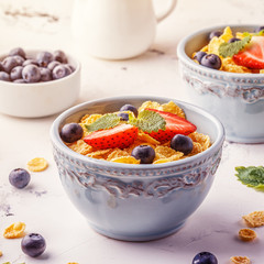 Healthy breakfast - corn flakes with fruits and berries.
