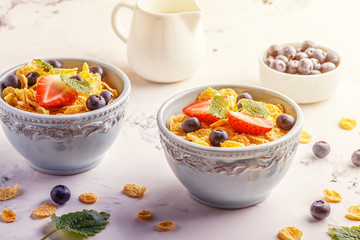 Healthy breakfast - corn flakes with fruits and berries. © tbralnina