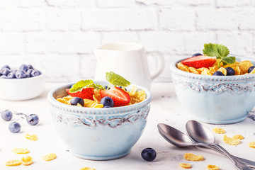 Healthy breakfast - corn flakes with fruits and berries. © tbralnina