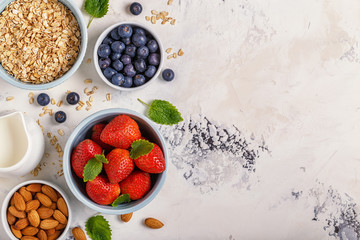 Healthy breakfast - a bowl of oatmeal, berries and fruit, top view.
