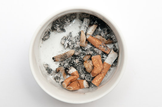 Full ashtray of cigarettes isolated on white