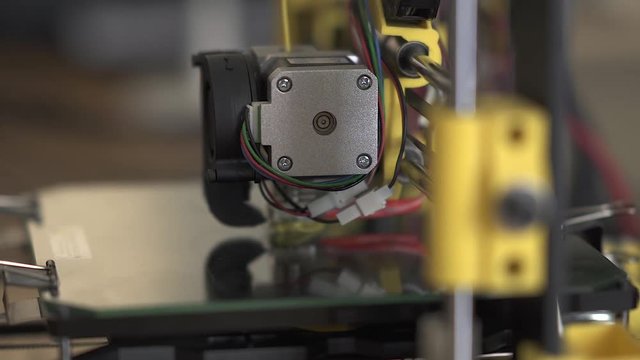 3D printer at work. 3D printing, additive manufacturing (AM), refers to processes used to create a three-dimensional object in which successive layers of material are formed under computer control