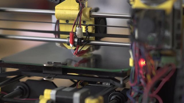 3D printer at work. 3D printing, additive manufacturing (AM), refers to processes used to create a three-dimensional object in which successive layers of material are formed under computer control