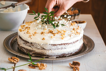 Decorating carrot cake with flowers