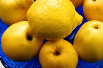 apples and lemons on a blue background