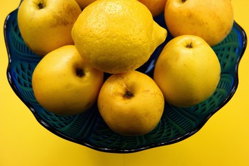 apples and lemons on a blue background