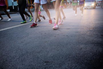 Fototapeta premium Movement of runners running in city street marathon on asphalt road.