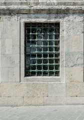 Front view of a metal grille on the window