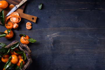 Fresh orange fruits, citrus harvest on wooden table. Top view, copy space.
