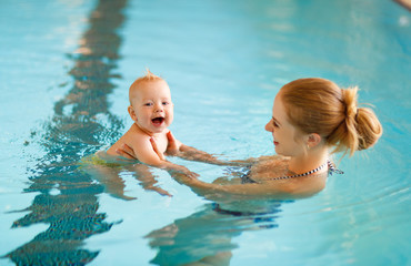 Mother and baby swim  in pool