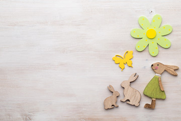 Spring and Easter decor. Wooden symbols bunny, flowers and butterflies.