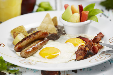Fried eggs with sausages and bacon