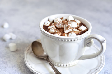 Hot chocolate with mini marshmellow in a white vintage cup.