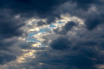 Cloudscape, background sky with reflected rays of the sun in clouds