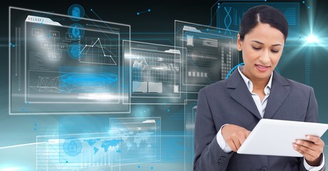 Digital composite image of a businesswoman using digital tablet 