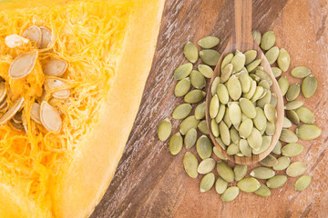Pumpkin seeds on the wooden background
