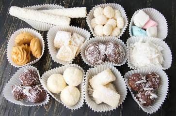 Various coconut candies and desserts in paper cups