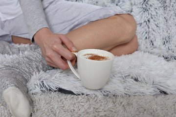 Cozy winter, Warmth concept. Woman wearing cozy warm wool socks close up.