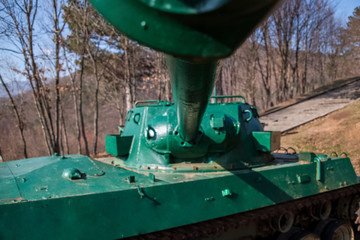 War artillery, tank shelling in the position of town, tube pointing toward the city