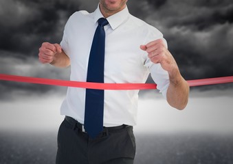 Excited businessman crossing the finish line