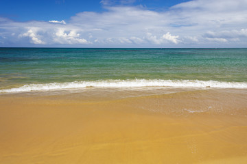 sea surf on the beach. Sand, sea, blue sky and white clouds