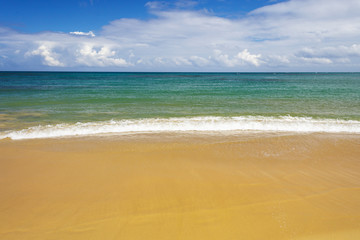 sea surf on the beach. Sand, sea, blue sky and white clouds