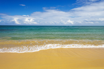 sea surf on the beach. Sand, sea, blue sky and white clouds