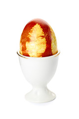 Colorful decorated easter egg in holder on white