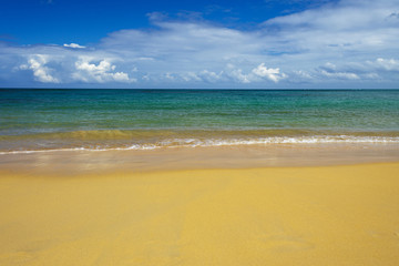 sea surf on the beach. Sand, sea, blue sky and white clouds