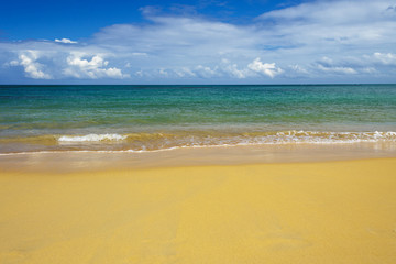 sea surf on the beach. Sand, sea, blue sky and white clouds