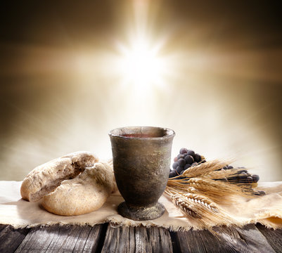 Communion - Unleavened Bread With Chalice Of Wine And Cross Light
