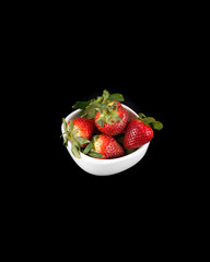 White bowl of whole red Strawberries on a black background vertical