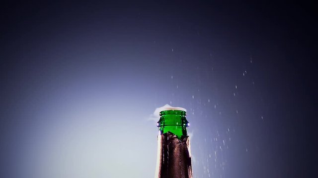 Bottle champagne wine is opened. Slow motion, lit background