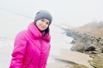 A beautiful young woman near the sea in winter