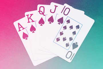 Royal Flush playing cards hand on colorful background