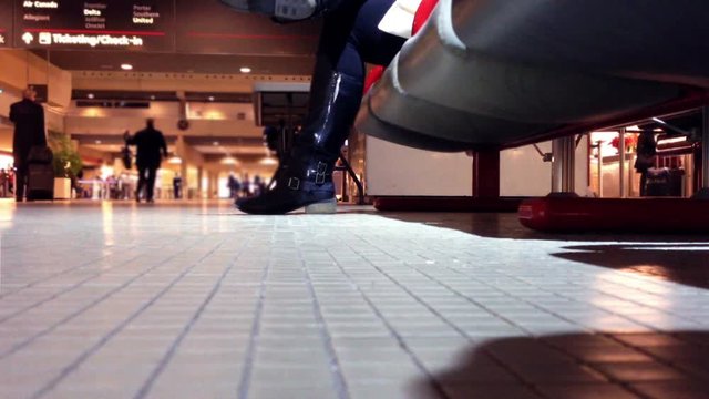 Woman waits at Airport Terminal