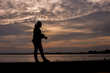 Fototapeta premium Man show hands silhouette sunset background